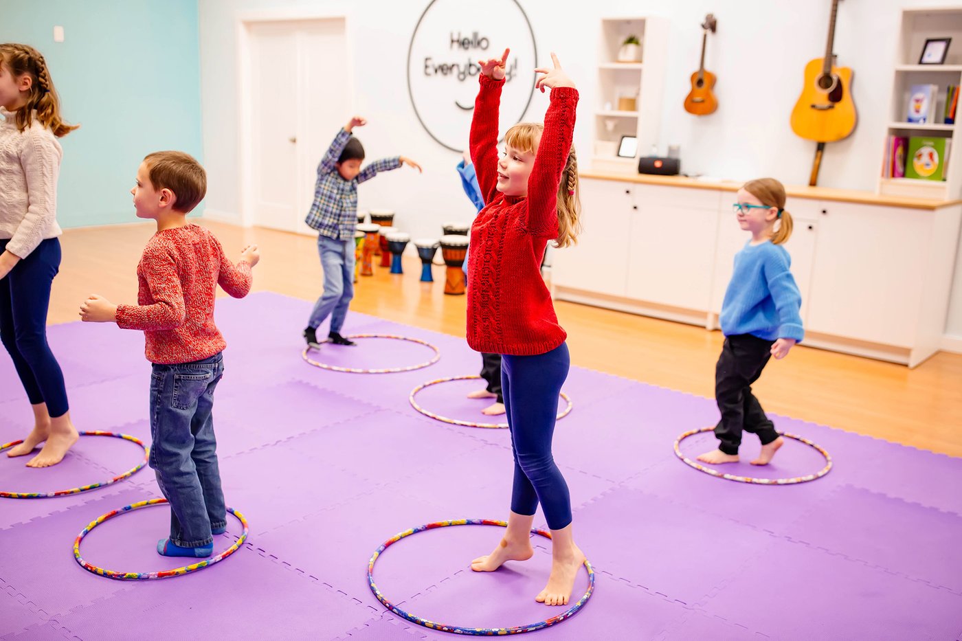 Elementary-age kids moving with hula hoops during a Rhythm Kids movement activity